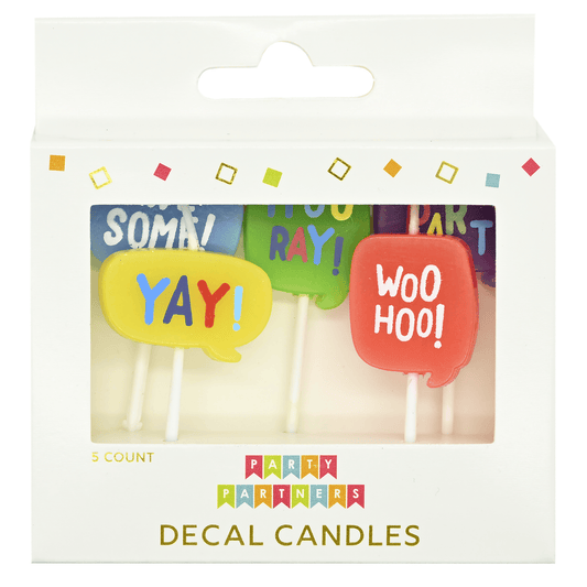 Set of Pictura candles with decorative decal words, featuring multiple white pillar candles arranged together.