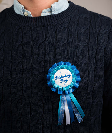 Blue birthday boy badge with paper glasses and wand accessories from Party Partners, perfect for birthday celebrations.