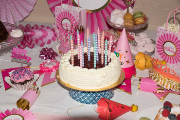 Set of 16 pastel white striped candles by Party Partners, arranged in a decorative display for special occasions.