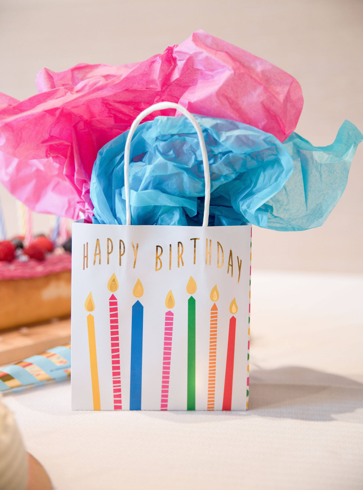 Colorful gift bags with happy birthday candles design, perfect for celebrating occasions by Party Partners.