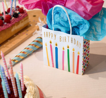 Party Partners gift bags featuring colorful happy birthday candles design, perfect for celebrating special occasions.