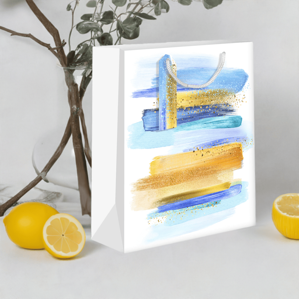 Medium Pictura gift bags in blue with gold accents, featuring elegant handles and decorative patterns for special occasions.
