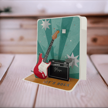 Pictura small guitar pop-up card with a detailed 3D guitar design that opens to reveal a colorful pop-up scene.