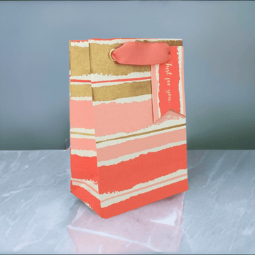 Pink painterly gift bag from Love Vivid featuring a small size with artistic floral design and sturdy handles.