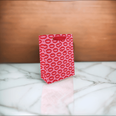 Love Vivid Kisses Med Gift Bag with colorful kiss print for gift presentation and packaging.