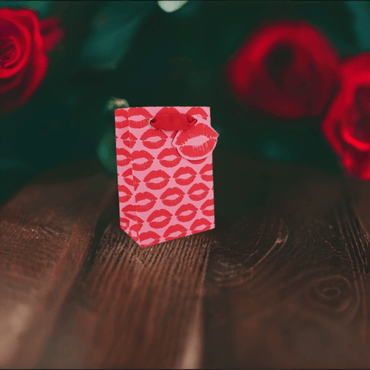 Love Vivid Kisses Small Gift Bag with colorful kiss print, perfect for gift wrapping and special occasions.