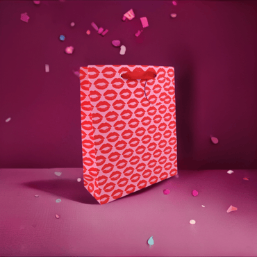 Large gift bag with "Kisses" printed in red and pink, featuring heart and kiss designs, by Love Vivid.