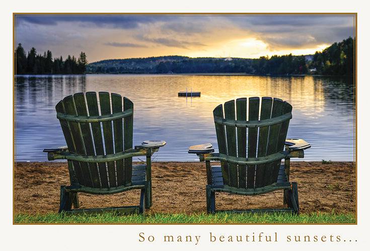 Two wooden chairs silhouetted against a sunset, featured on a Pictura everyday anniversary card.