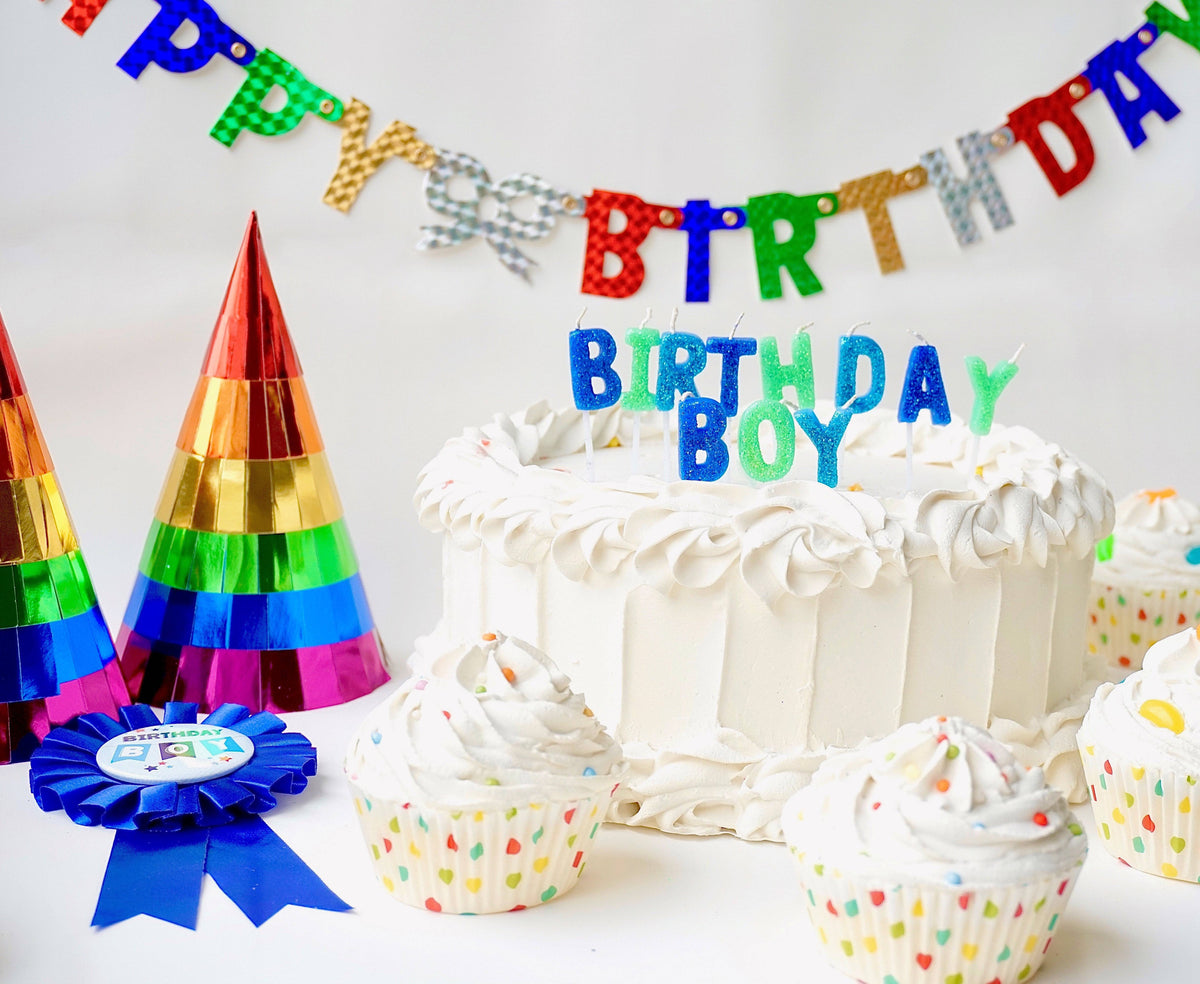 Colorful rainbow foil party hats by Party Partners, perfect for birthday celebrations, with shiny metallic finish and festive design.