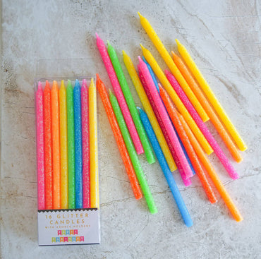 Tall neon rainbow candles set by Party Partners featuring vibrant, colorful candles with a tall, sleek design.