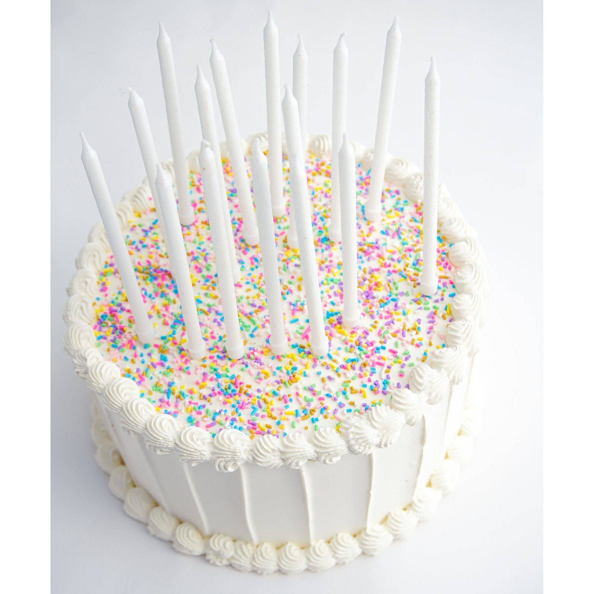 Tall white glitter candles from Party Partners Candle Set, featuring elegant white candles with sparkling glitter finish.