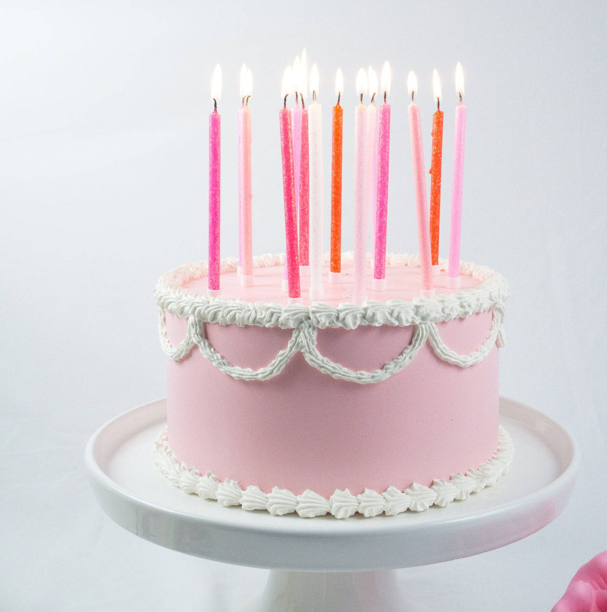 Tall pink gradient candles from Party Partners' candle set, featuring sleek, tapered designs ideal for decorative lighting.