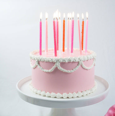Tall pink gradient candles from Party Partners' candle set, featuring sleek, tapered designs ideal for decorative lighting.