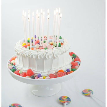 Tall white glitter candles from Party Partners Candle Set, with smooth white surfaces and shimmering glitter accents.