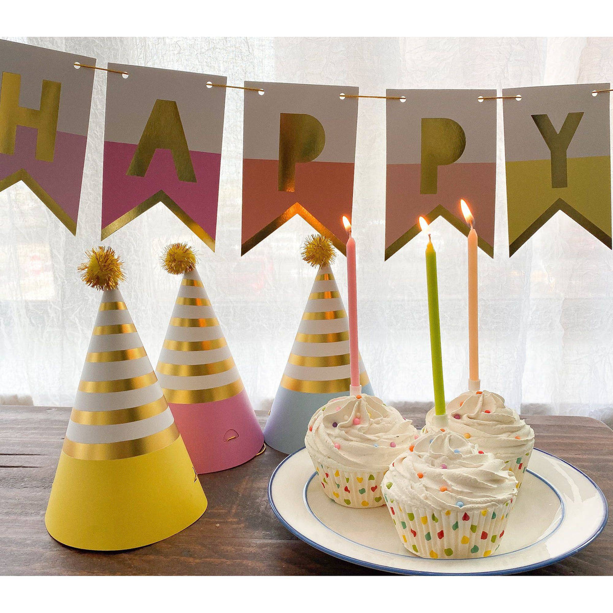 Colorful pastel party hats by Party Partners, decorated with vibrant patterns, perfect for celebrations and festive events.
