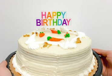 Decorative "Happy Bday" cake topper by Party Partners, featuring festive design on a white background.